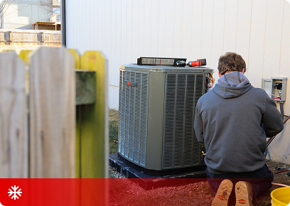 Cooling CTA KB Complete technician kneeling in front of an outdoor air conditioning condenser