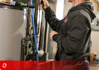 Plumbing CTA KB Complete technician working on the top connections of a water heater