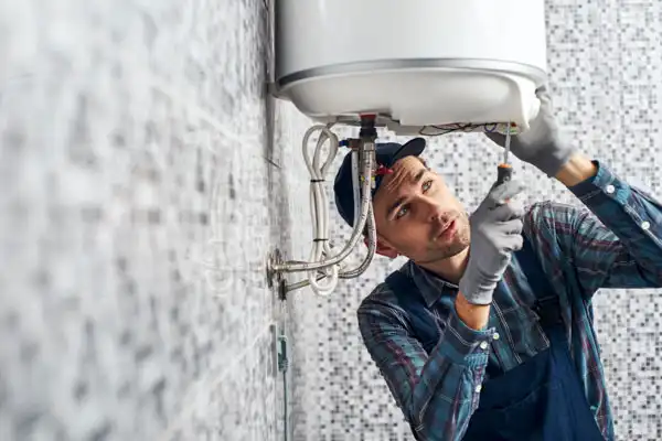 Closeup of man working on a boiler