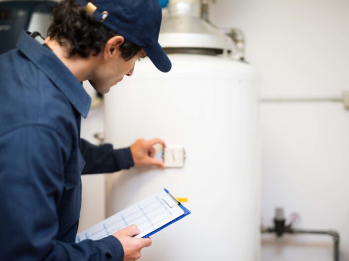 Plumber repairing a hot water heater