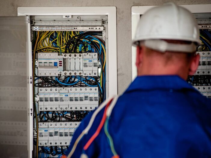 Electrician inspecting a circuit breaker