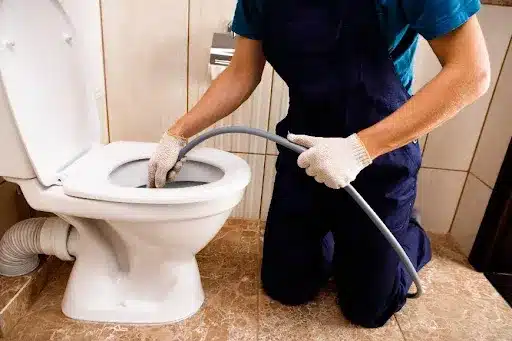 https://kbcomplete.com/wp-content/uploads/2023/09/Plumber-using-high-pressure-drain-cleaning-tool-to-clear-a-clog-from-the-plumbing-system-in-a-Mission-KS-home.webp